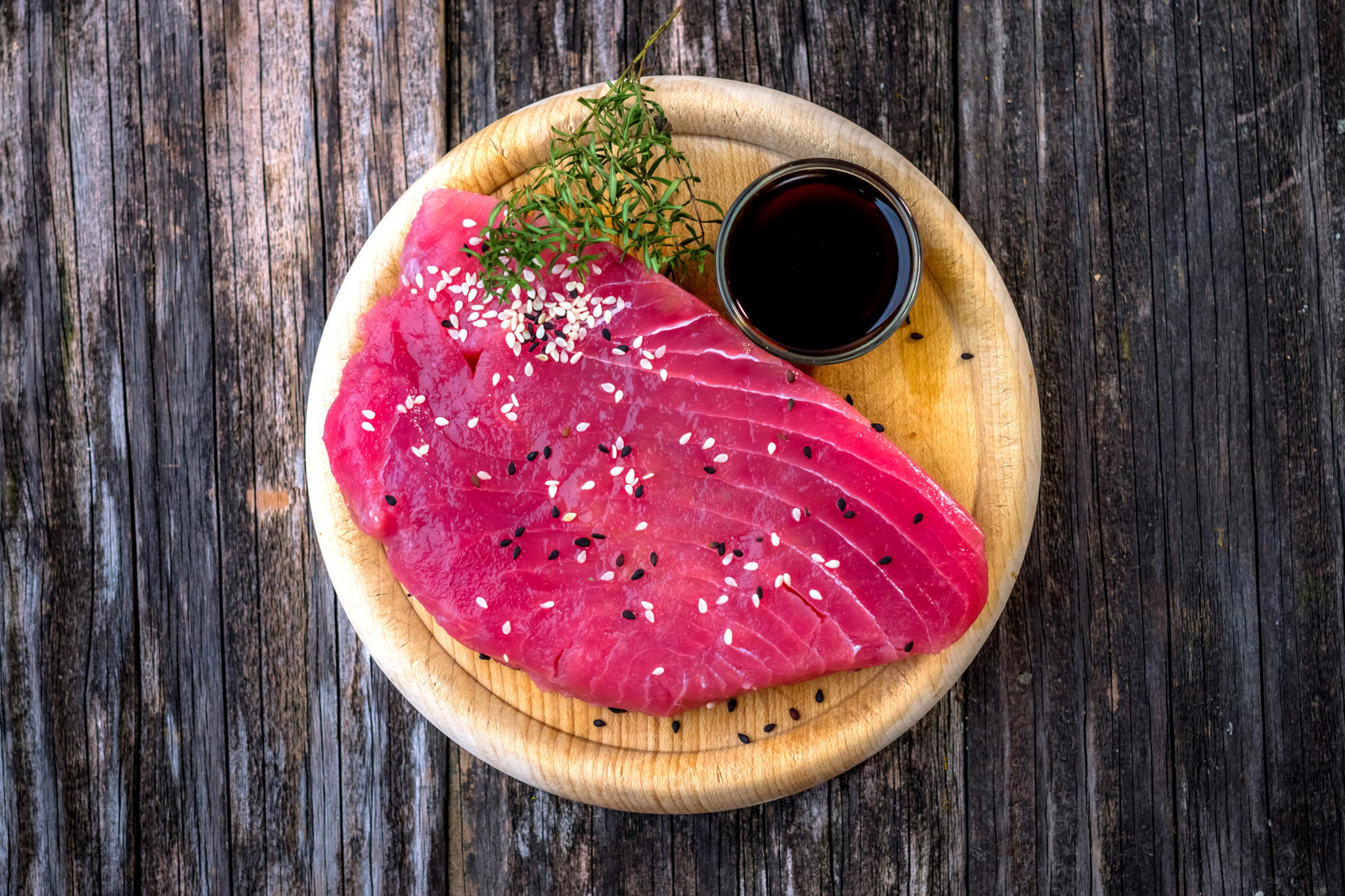 Raw tuna fillet with soya sauce  on rustic background